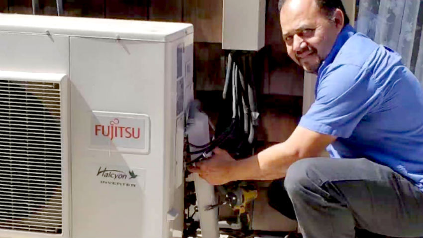 Technician installing a tankless water heater